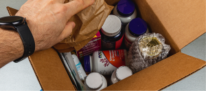 A cardboard box full of vitamin bottles
